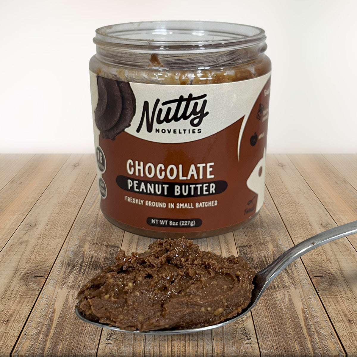 Chocolate Peanut Butter with spoon full of peanut butter in front of container